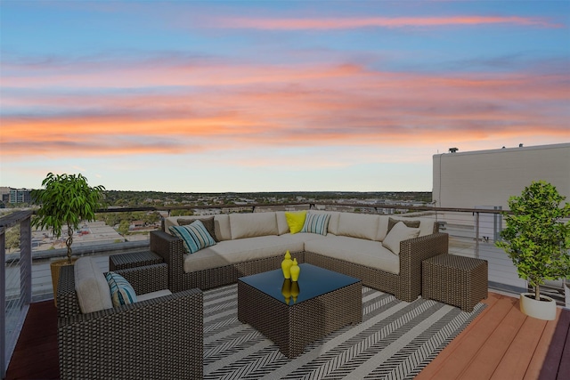 deck at dusk featuring an outdoor living space