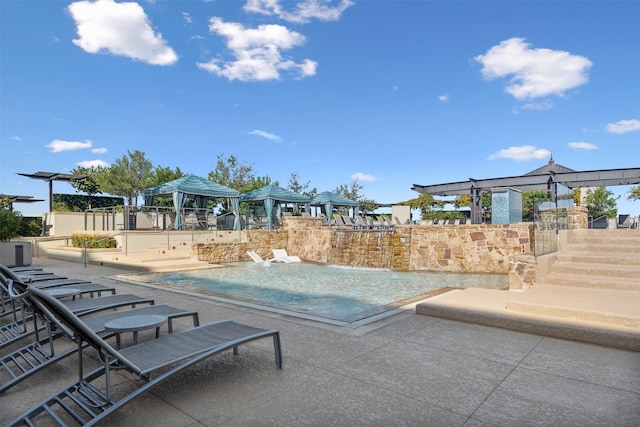 view of pool with a gazebo, a patio, and pool water feature