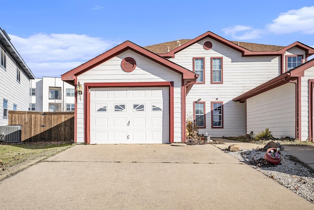 view of front of home featuring a garage and central AC unit