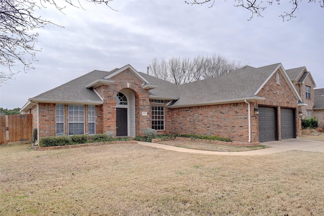 ranch-style home featuring a front lawn and a garage