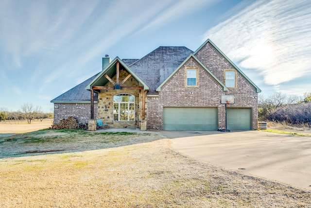 view of front of house with a front yard and a garage