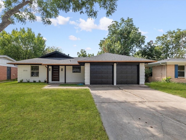 view of front of property with a front yard and a garage