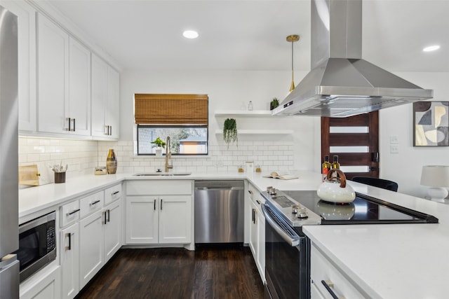 kitchen featuring white cabinets, stainless steel appliances, sink, hanging light fixtures, and island range hood