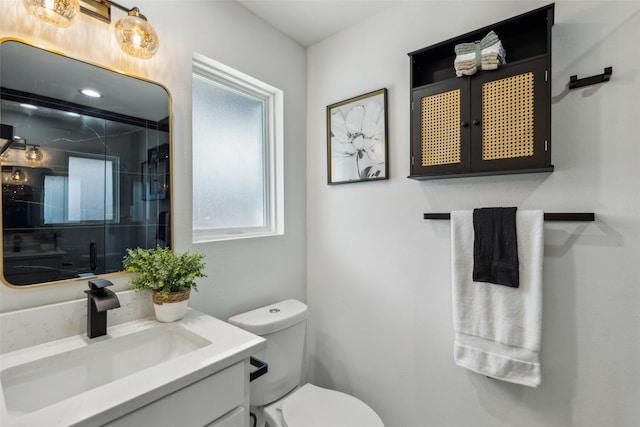 bathroom featuring toilet and vanity