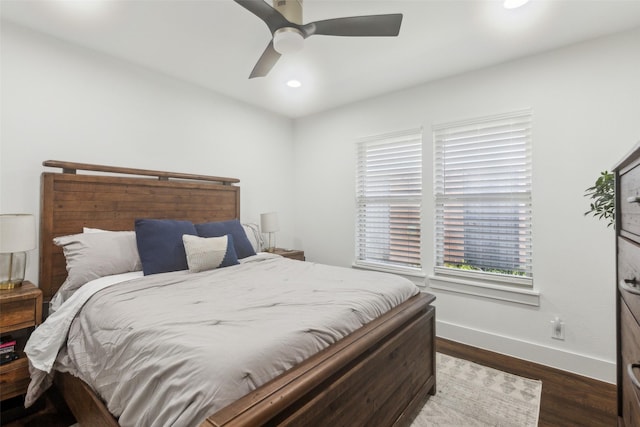 bedroom with ceiling fan and dark hardwood / wood-style flooring