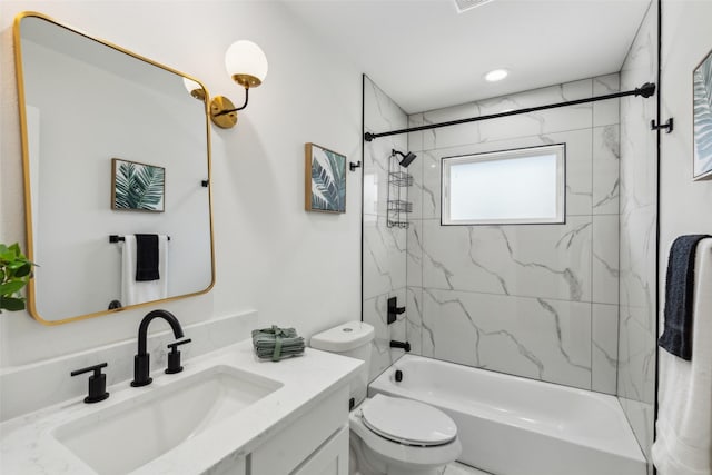 full bathroom with toilet, vanity, and tiled shower / bath combo