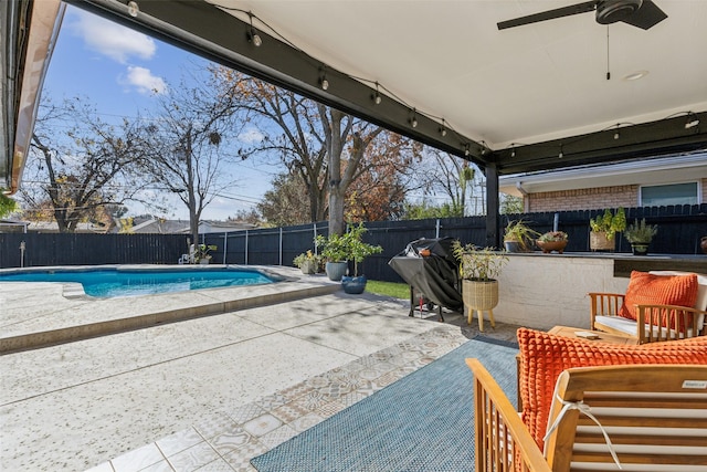 view of swimming pool with ceiling fan and a patio