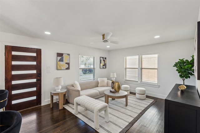 living room featuring ceiling fan and dark hardwood / wood-style flooring