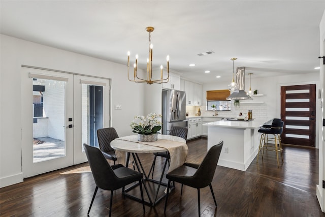 dining area featuring french doors, plenty of natural light, and dark hardwood / wood-style floors