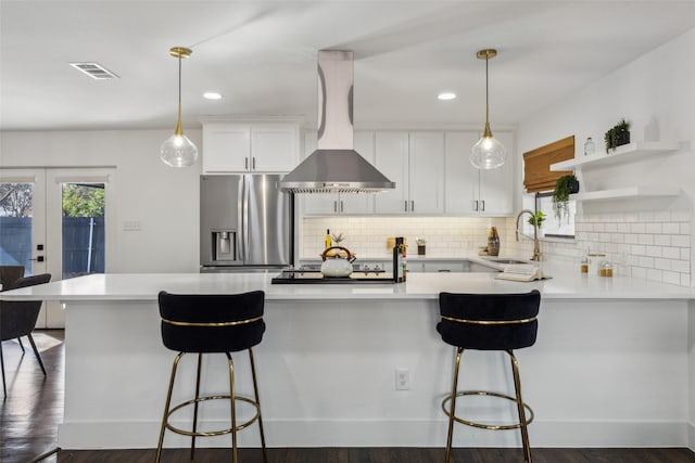 kitchen with white cabinets, stainless steel refrigerator with ice dispenser, island exhaust hood, and pendant lighting