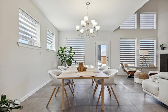 dining space with tile patterned floors and an inviting chandelier