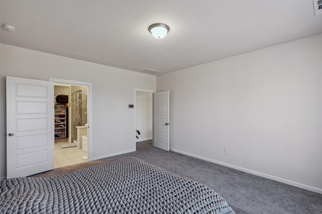 unfurnished bedroom with connected bathroom and light colored carpet