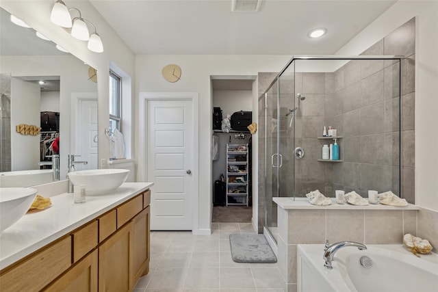 bathroom with independent shower and bath, tile patterned flooring, and vanity