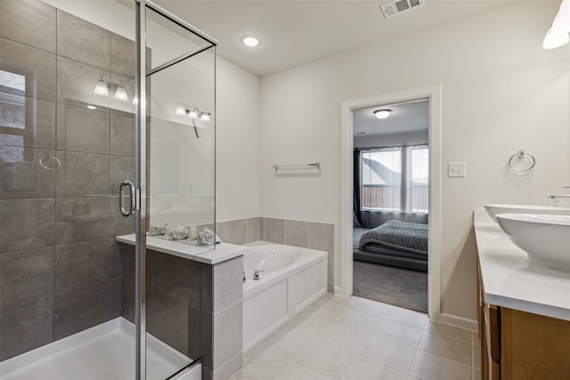 bathroom with separate shower and tub, vanity, and tile patterned floors