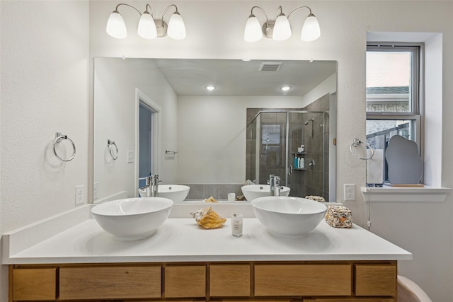 bathroom featuring vanity and a shower with shower door