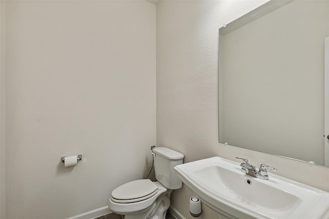 bathroom featuring sink and toilet