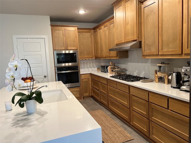 kitchen featuring appliances with stainless steel finishes and dark tile patterned flooring