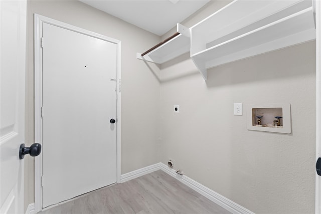 laundry area featuring gas dryer hookup, light hardwood / wood-style floors, electric dryer hookup, and hookup for a washing machine