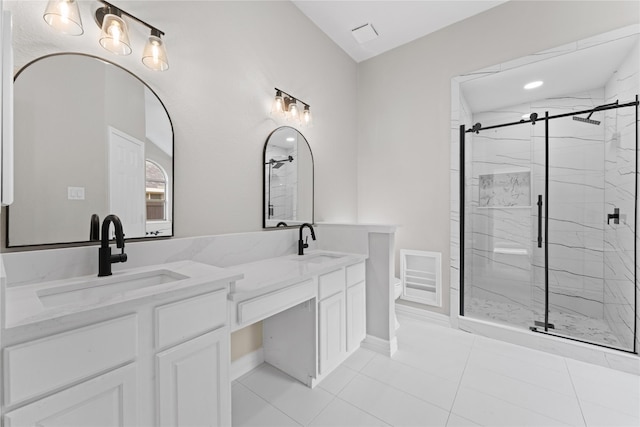 bathroom featuring toilet, vanity, tile patterned flooring, and a shower with shower door