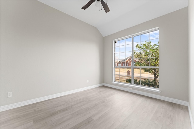 unfurnished room featuring lofted ceiling, light wood-type flooring, and ceiling fan