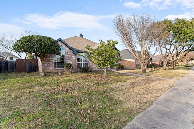 ranch-style house featuring cooling unit and a front yard