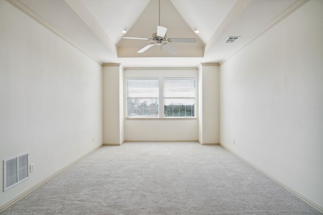 carpeted spare room with lofted ceiling, ceiling fan, and a tray ceiling