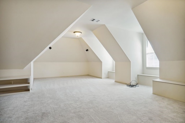 bonus room featuring lofted ceiling and light colored carpet