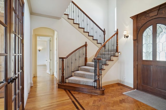 entryway featuring french doors and crown molding