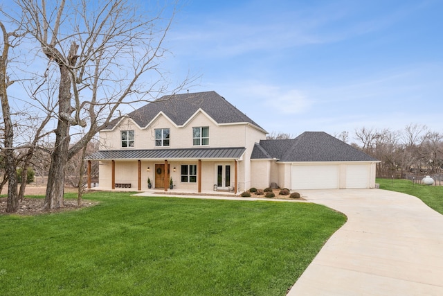 modern farmhouse featuring a porch, a front yard, and a garage