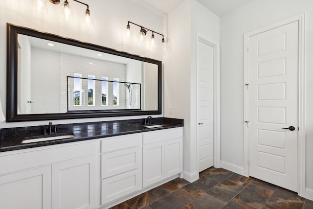 bathroom with a shower with door and vanity