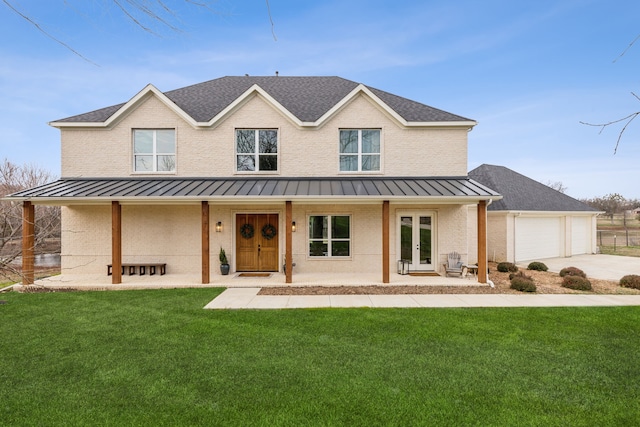 view of front of property featuring french doors, a front lawn, and a garage