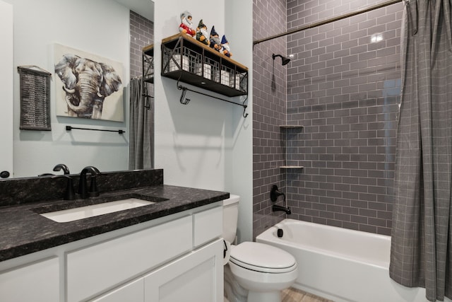 full bathroom with shower / tub combo, vanity, and toilet