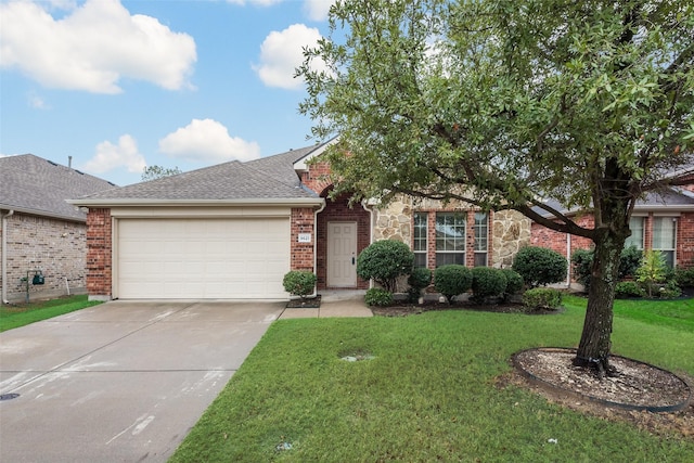 view of front of property with a front lawn and a garage