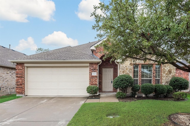 view of front of property with a front lawn and a garage