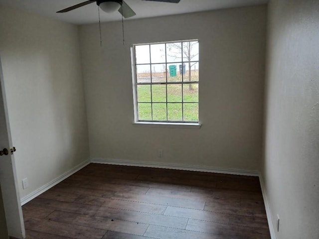 empty room with baseboards, plenty of natural light, ceiling fan, and hardwood / wood-style flooring
