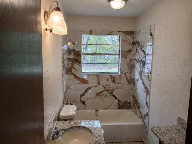 full bathroom with a textured wall, bathtub / shower combination, and a sink