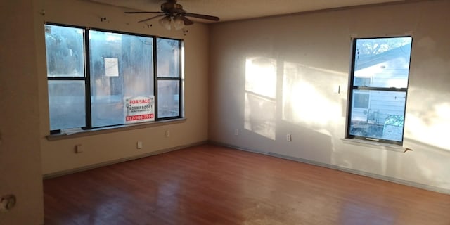 empty room featuring hardwood / wood-style flooring and ceiling fan