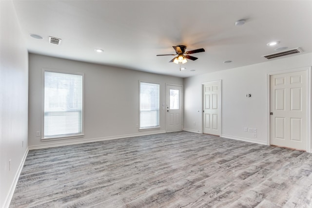 spare room with ceiling fan and light hardwood / wood-style flooring