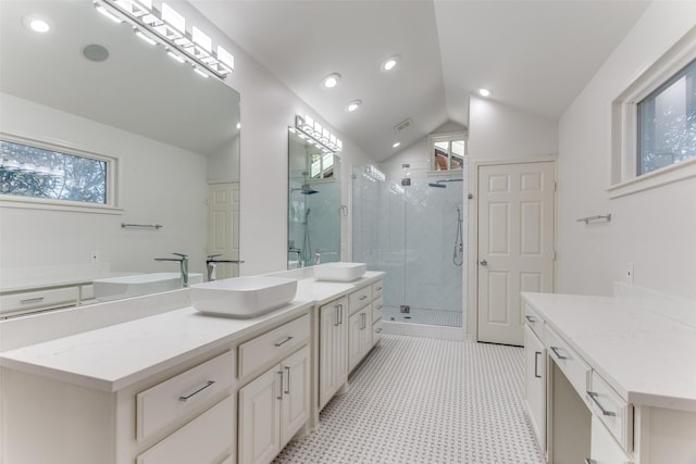 bathroom with walk in shower, lofted ceiling, and vanity