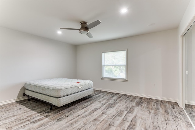 bedroom featuring light wood-type flooring and ceiling fan