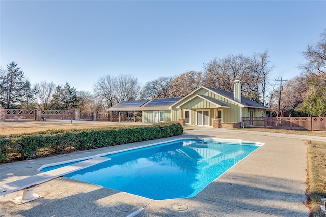 view of pool featuring a diving board