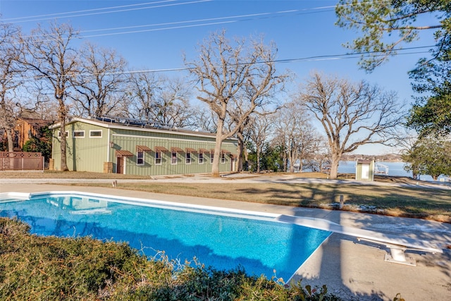 view of pool featuring an outdoor structure and a diving board