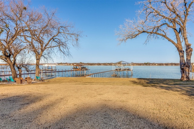 exterior space featuring a dock and a water view