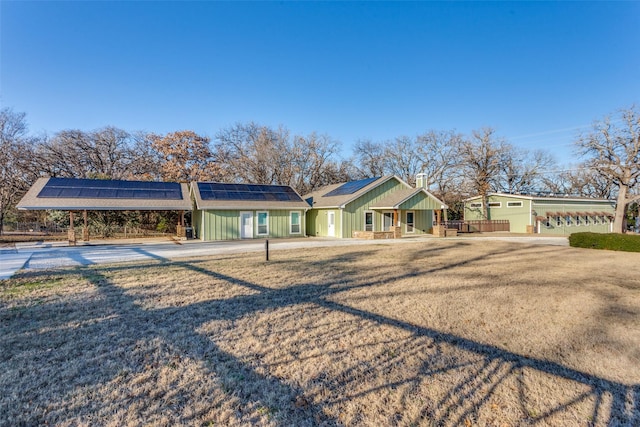 ranch-style home featuring solar panels and a garage