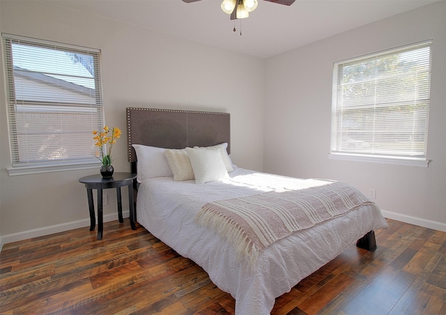 bedroom with dark hardwood / wood-style flooring and ceiling fan