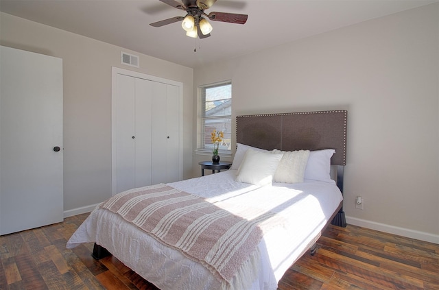 bedroom featuring ceiling fan, a closet, and dark hardwood / wood-style floors