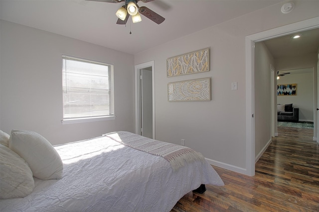 bedroom with ceiling fan and dark hardwood / wood-style floors