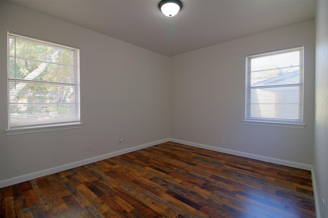 empty room featuring dark hardwood / wood-style flooring