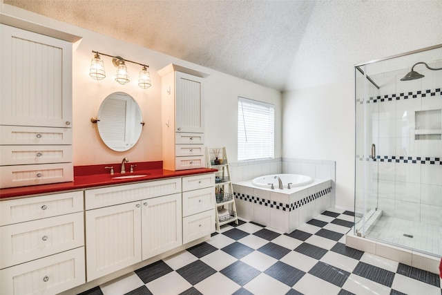 bathroom with plus walk in shower, vaulted ceiling, vanity, and a textured ceiling