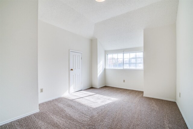 bathroom featuring lofted ceiling, vanity, a textured ceiling, and plus walk in shower